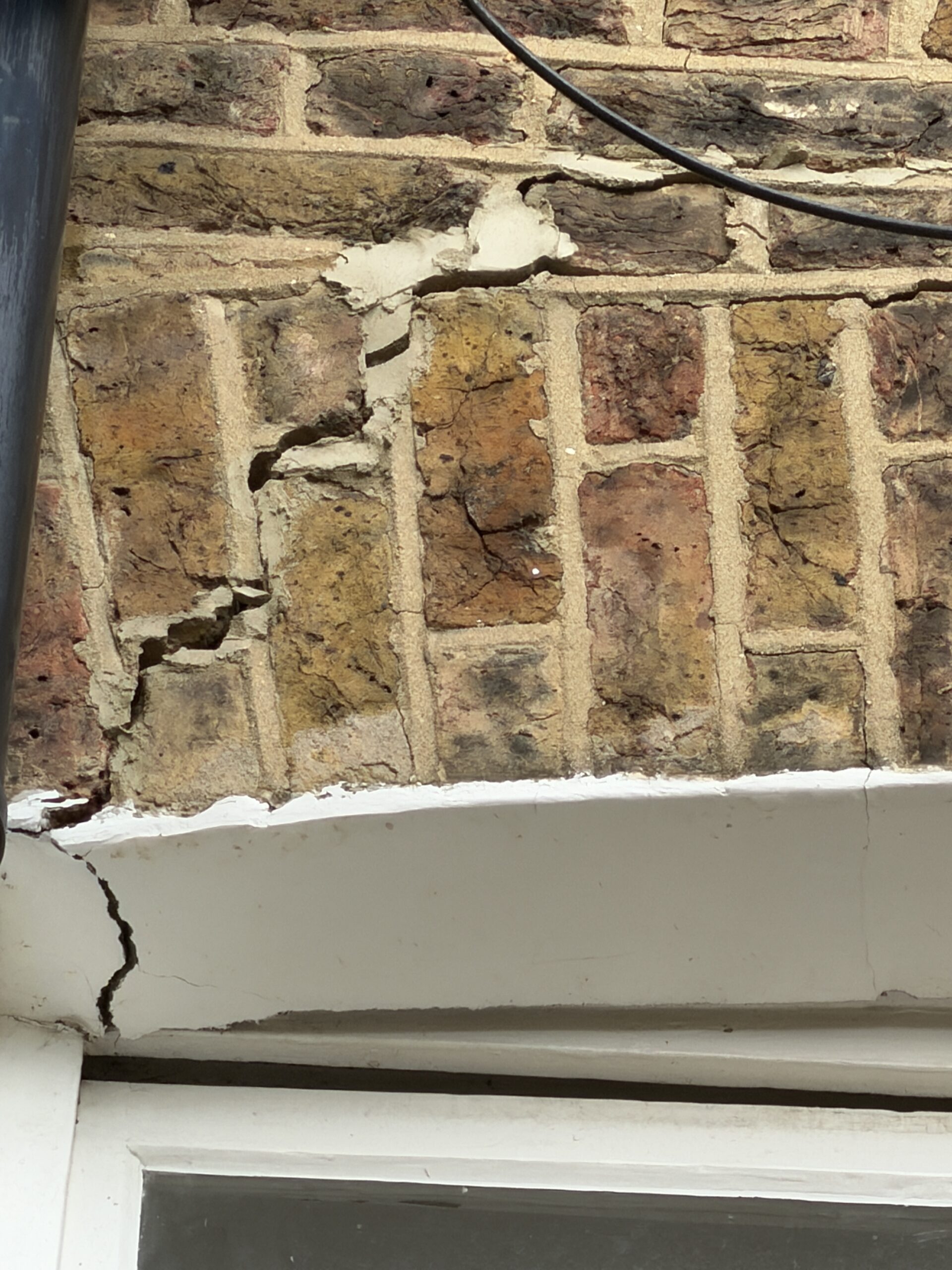 Cracked external brickwork showing signs of structural movement