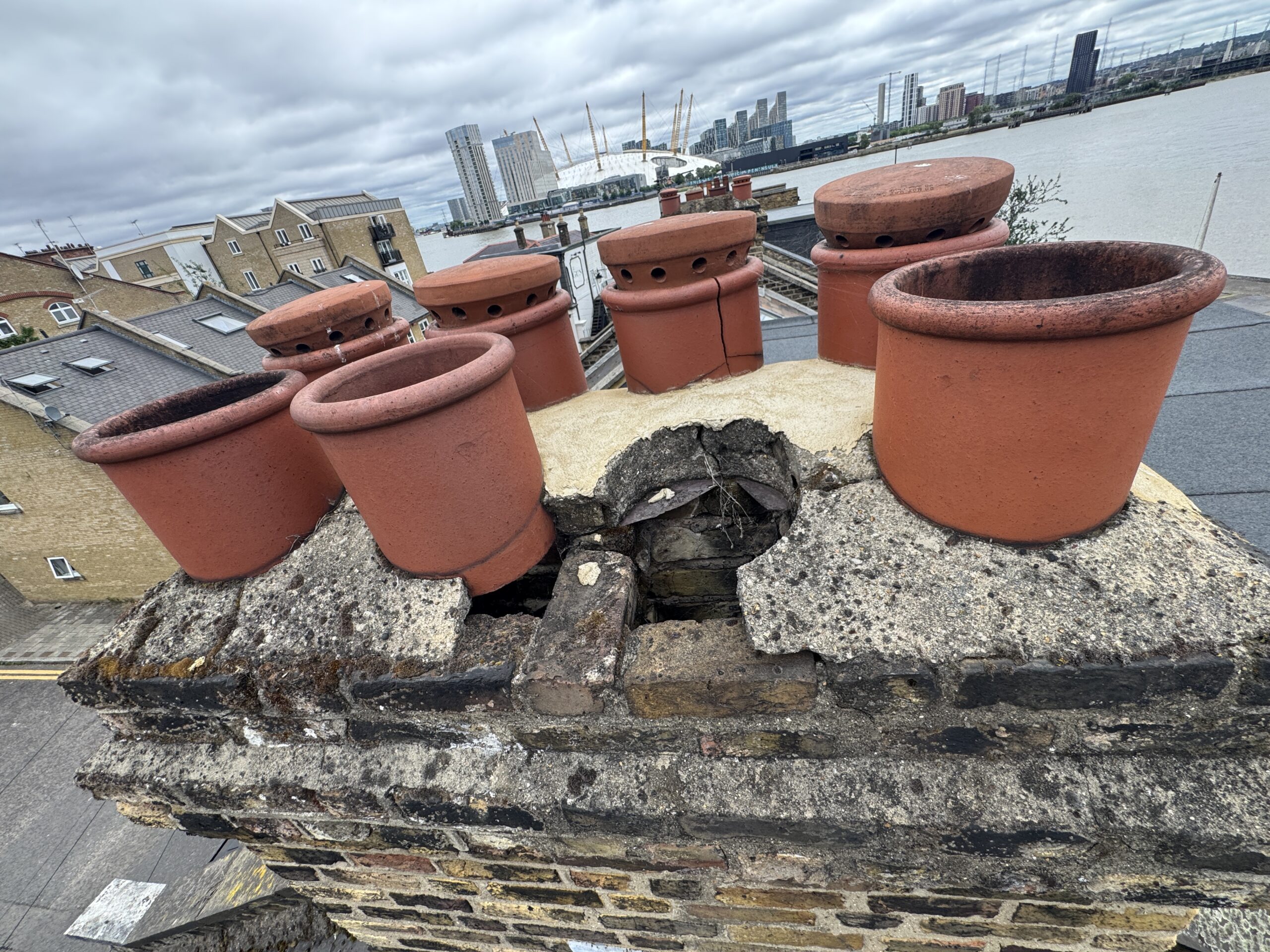 Defective chimney stack with collapsed brickwork captured by drone during a home survey
