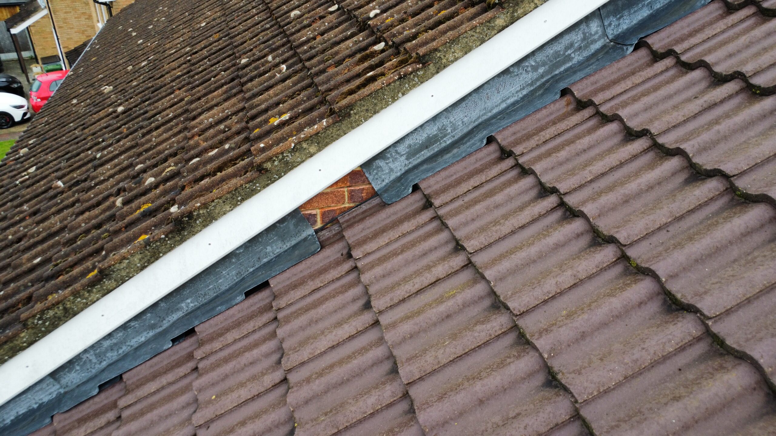 Slipped and poorly detailed lead flashing at a roof/wall abutment
